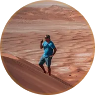 Andrej standing on a dune ridge in the desert